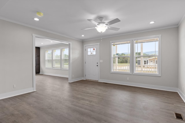 entryway featuring dark wood-type flooring, ornamental molding, a wealth of natural light, and ceiling fan