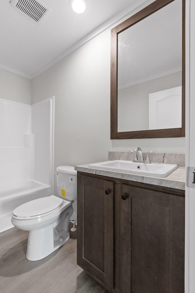 full bathroom featuring shower / bath combination, hardwood / wood-style flooring, vanity, and toilet