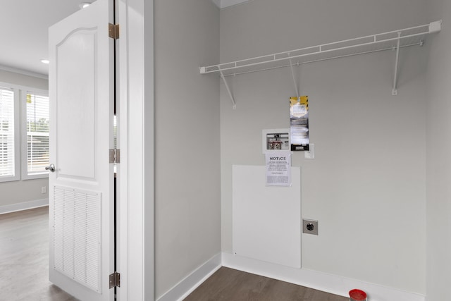 washroom featuring hardwood / wood-style flooring and electric dryer hookup