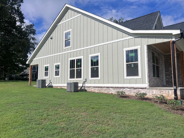 view of property exterior featuring a lawn and central AC