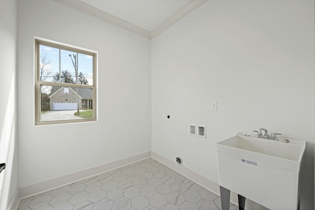 washroom with baseboards, laundry area, a sink, washer hookup, and electric dryer hookup