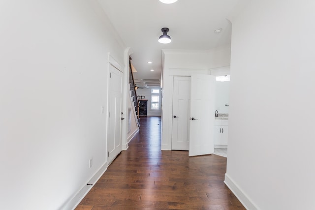 hall with dark hardwood / wood-style flooring and sink