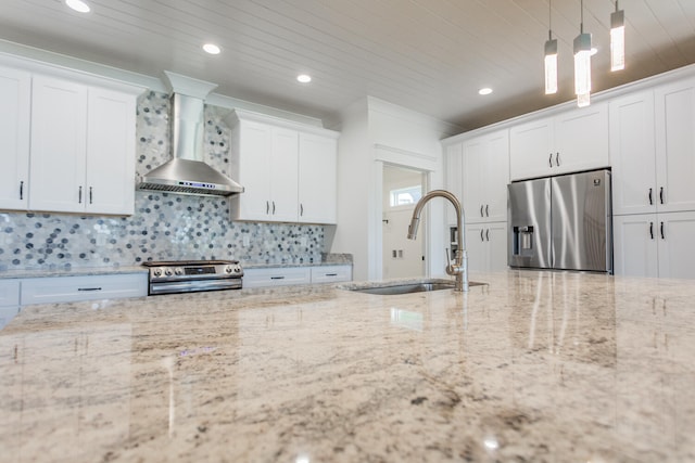 kitchen featuring stainless steel appliances, sink, wall chimney range hood, and white cabinetry