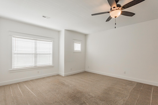 carpeted empty room featuring ceiling fan