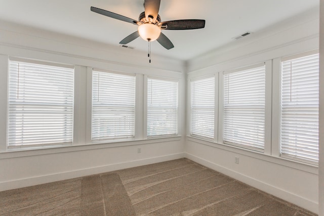 unfurnished sunroom featuring ceiling fan