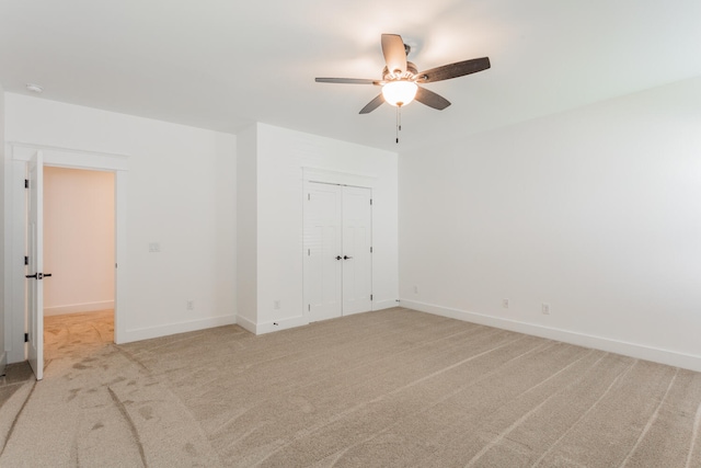 unfurnished room with ceiling fan and light carpet