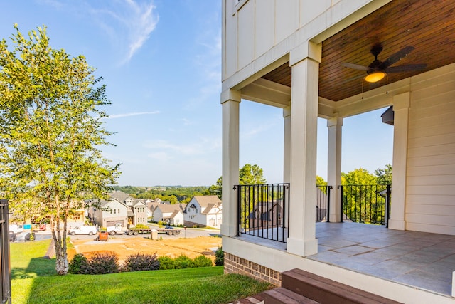 view of yard with a porch and ceiling fan