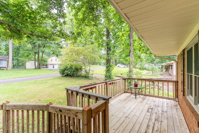 deck featuring a storage shed and a yard