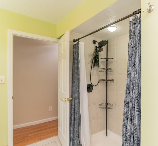 bathroom featuring walk in shower and hardwood / wood-style flooring