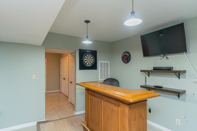 interior space featuring light tile patterned flooring and hanging light fixtures