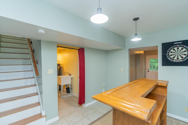 interior space with light tile patterned flooring and hanging light fixtures