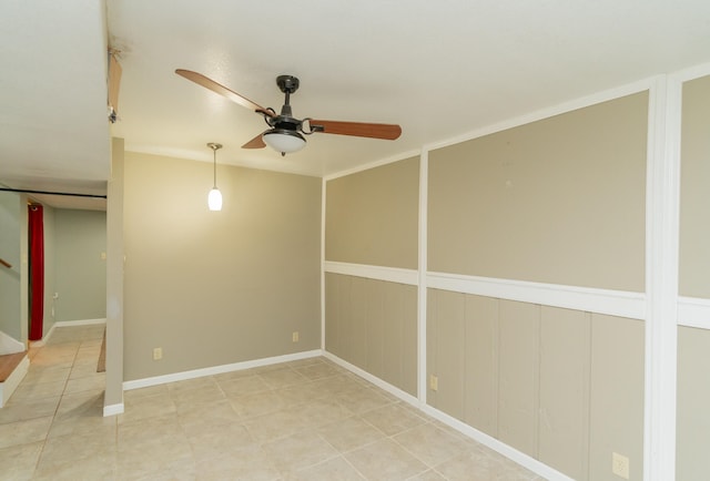 tiled spare room featuring ceiling fan