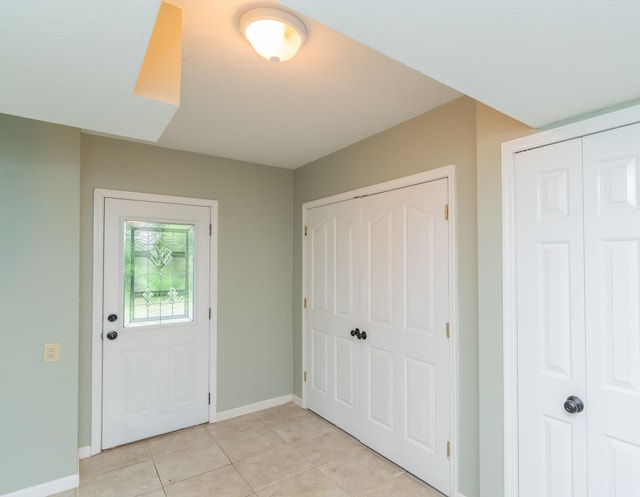 entryway with light tile patterned floors