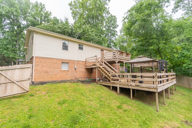 back of house with a yard and a wooden deck