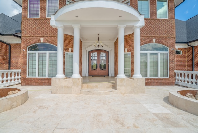 doorway to property with a porch and french doors