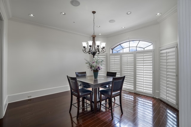 dining area with a notable chandelier, dark hardwood / wood-style flooring, and crown molding