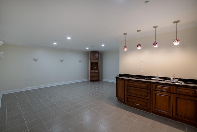 kitchen with crown molding, light tile patterned floors, and sink