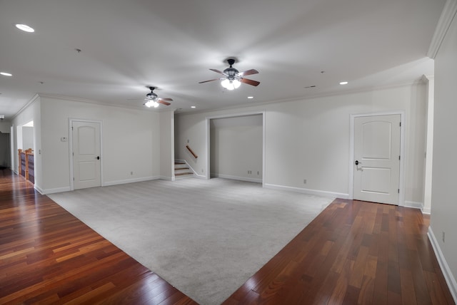 carpeted empty room featuring ceiling fan and crown molding