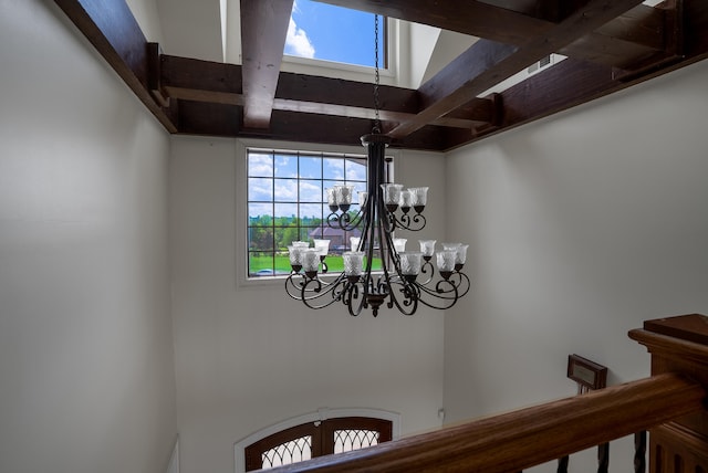 details with a chandelier and beamed ceiling