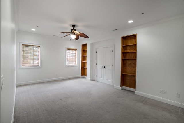 unfurnished bedroom with crown molding, ceiling fan, and light colored carpet