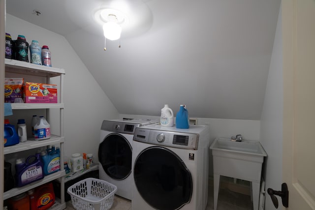 clothes washing area featuring sink and separate washer and dryer