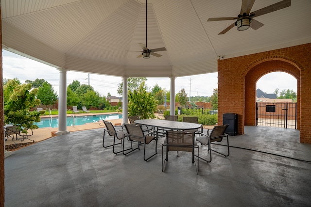 view of patio featuring a fenced in pool and ceiling fan