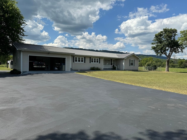 view of front of property featuring a garage and a front lawn