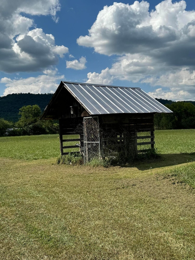 view of horse barn featuring a rural view