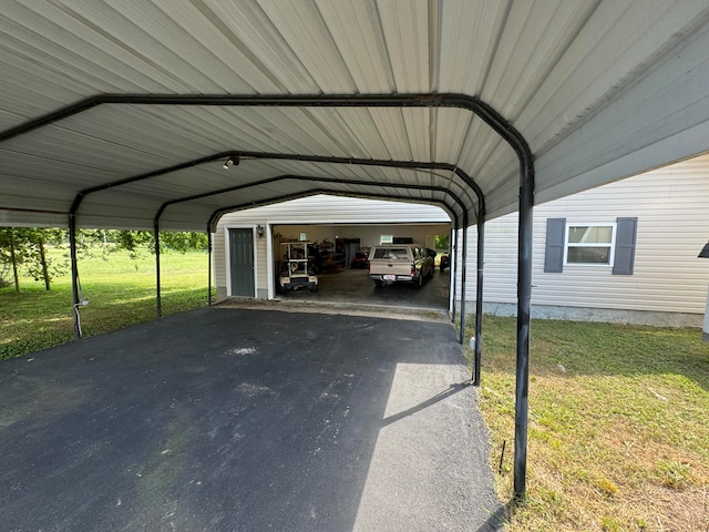 view of parking / parking lot with a yard and a garage