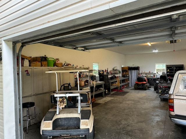 garage featuring a garage door opener and a workshop area