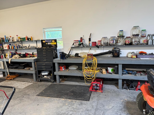 interior space featuring concrete flooring and a workshop area