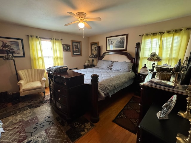 bedroom with ceiling fan and dark hardwood / wood-style floors