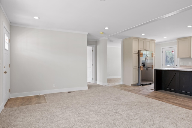 interior space with ornamental molding and light hardwood / wood-style floors