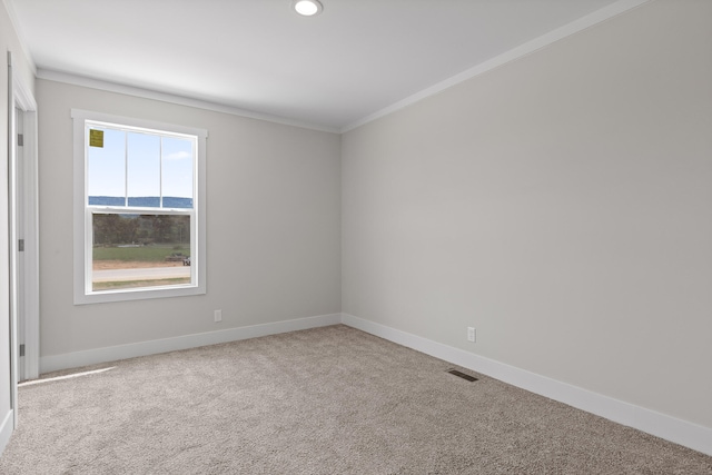 carpeted empty room with a water view and ornamental molding