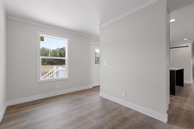 empty room featuring ornamental molding and hardwood / wood-style floors