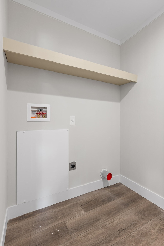 laundry room with washer hookup, crown molding, dark hardwood / wood-style floors, and hookup for an electric dryer