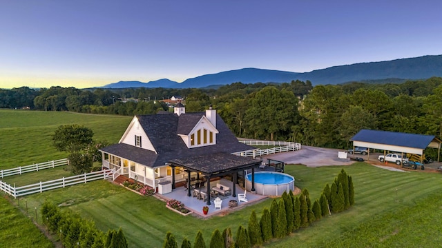 birds eye view of property with a mountain view and a rural view