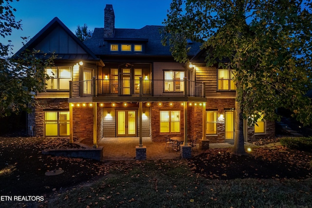 rear view of property with a balcony and a patio area