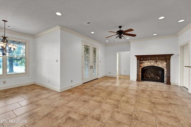 unfurnished living room with ornamental molding, ceiling fan with notable chandelier, and a fireplace