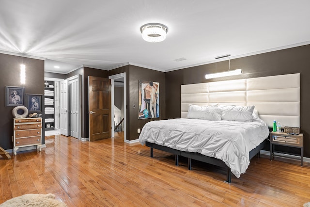 bedroom with light hardwood / wood-style flooring and crown molding