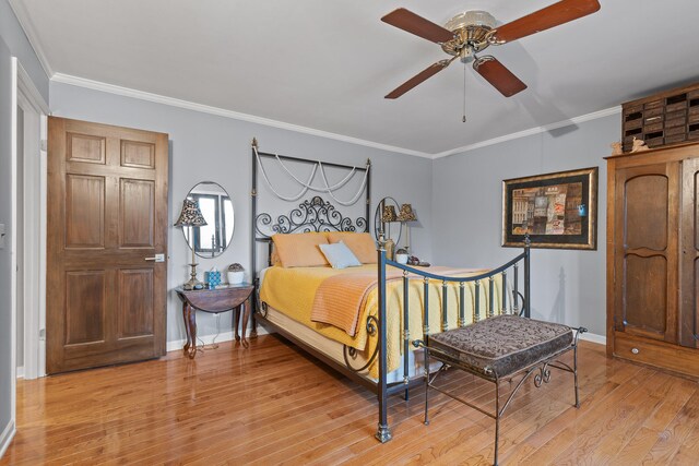 bedroom with light hardwood / wood-style flooring, ceiling fan, and crown molding