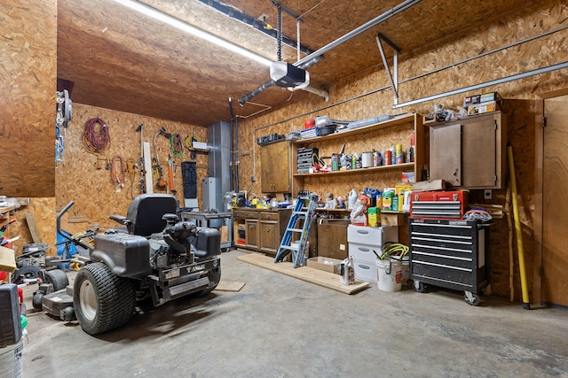 garage with a garage door opener and a workshop area