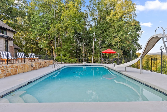 view of swimming pool featuring a water slide