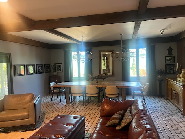 living room featuring a wealth of natural light, a chandelier, and beamed ceiling