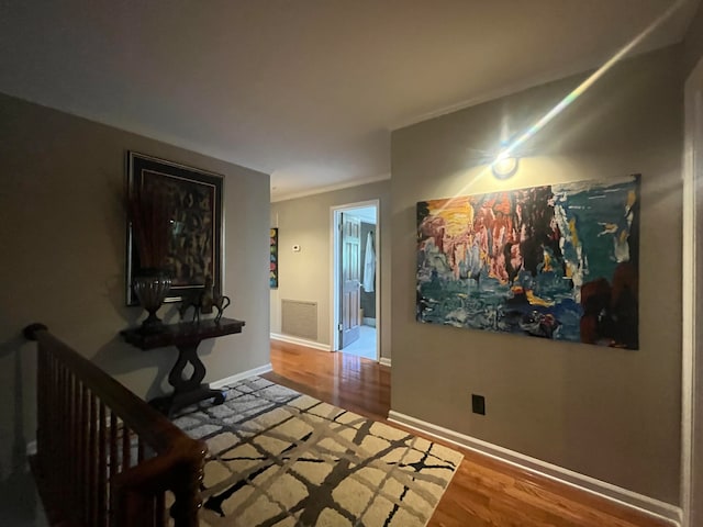 bedroom with ornamental molding and hardwood / wood-style floors