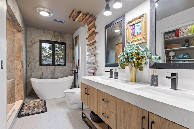 full bathroom with vanity, tile patterned floors, shower with separate bathtub, tile walls, and toilet