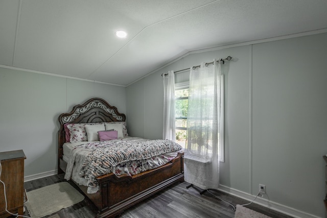 bedroom featuring lofted ceiling and dark hardwood / wood-style floors