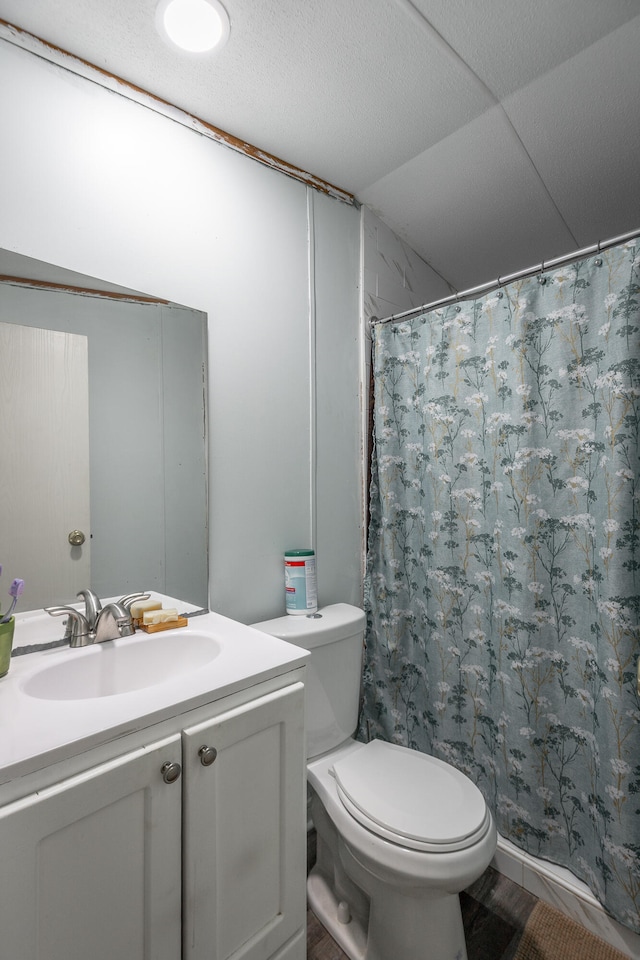 bathroom with vanity, toilet, walk in shower, and lofted ceiling