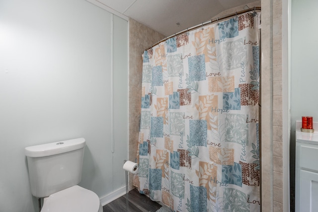 bathroom featuring a shower with shower curtain, wood-type flooring, and toilet