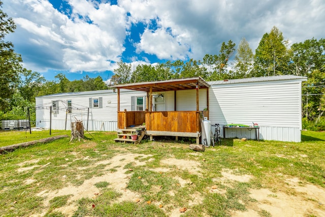 rear view of property featuring a yard